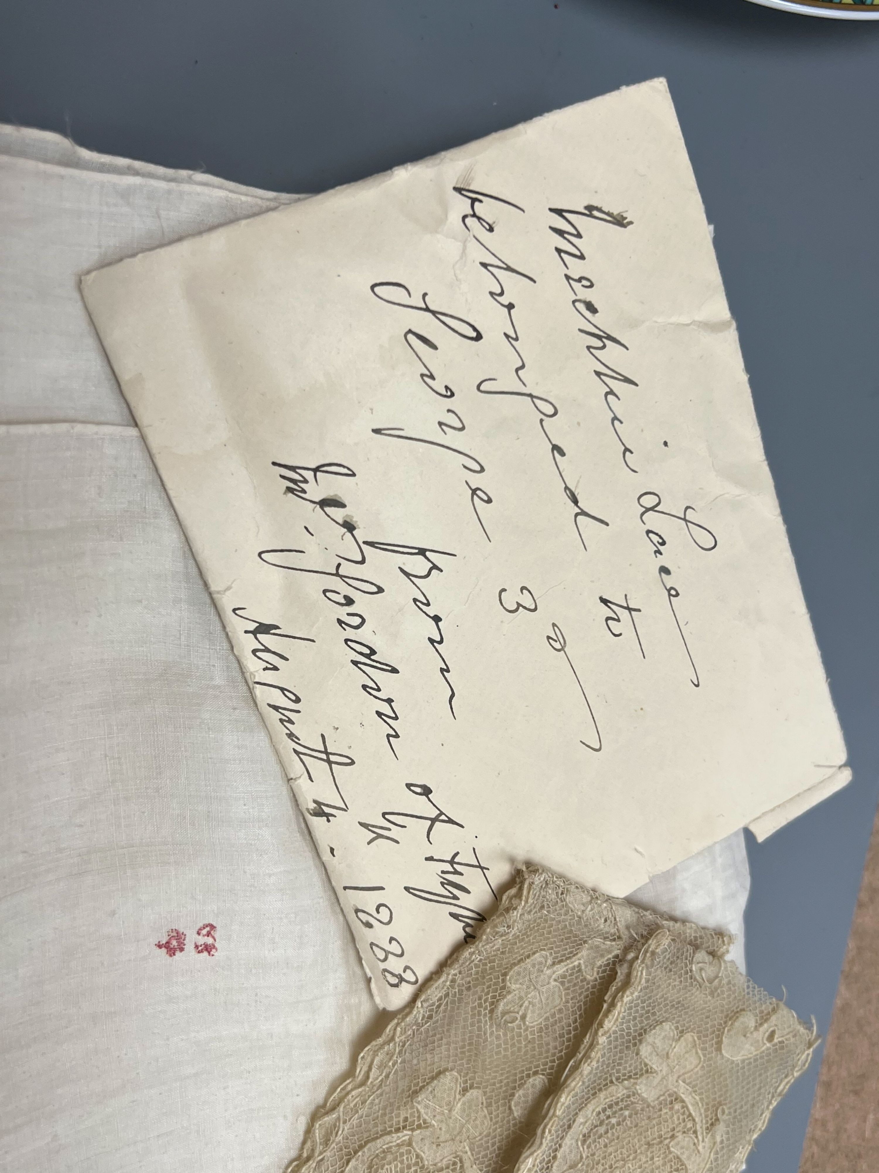 A George III handkerchief with George III cypher and three pieces of lace (4)